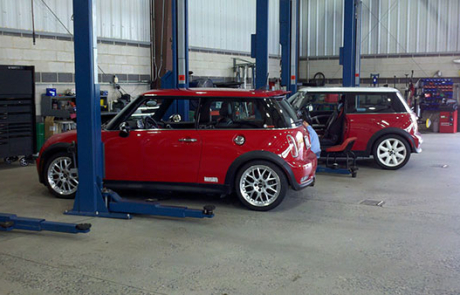 Two Red MINIs Getting Serviced